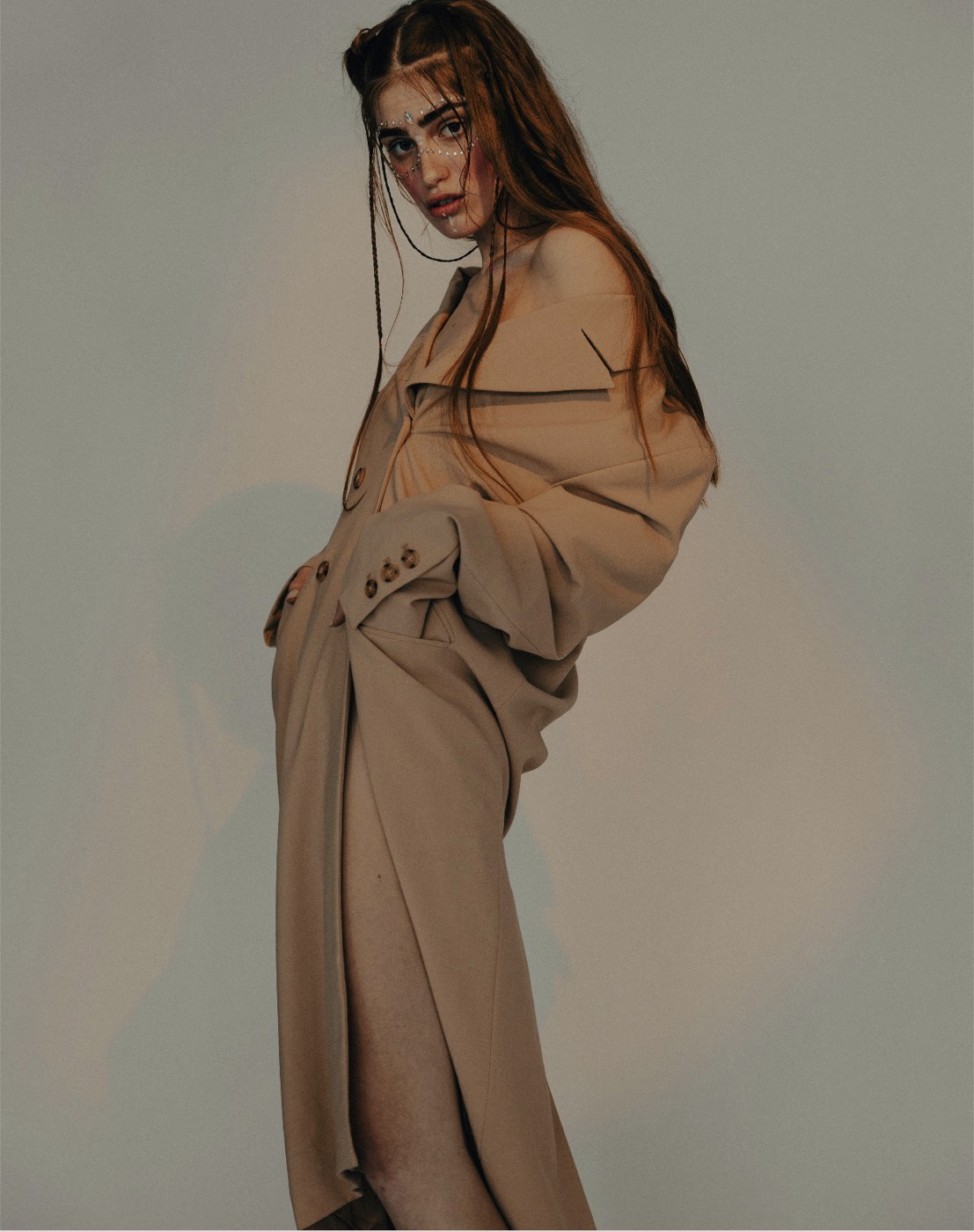 Editorial portrait of a woman in a muted, warm-toned trench coat — the visual world of Harriet Castle's boundaries app